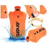A collage of images showing an orange inflatable safety buoy for swimming, with some images showing it in water and one showing a towel being placed inside. Produktbild-Vorschau