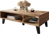 A coffee table with storage shelves, decorated with books, a vase of flowers, and decorative objects. Voir les images du produit