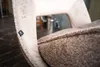 A close-up view of a chair's upholstery and a small brand tag. Produktbild-Vorschau