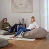 Two people relaxing on large beanbag chairs in a modern living room. Produktbild-Vorschau