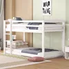 A white bunk bed with bedding in a room with light green walls and wooden cabinets. Produktbild-Vorschau