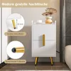 A white nightstand with gold accents is shown in a room setting, with close-up insets highlighting its features. Produktbild-Vorschau