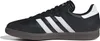 A side view of a black Adidas Samba shoe with white stripes and a brown sole. Náhled obrázku produktu