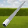 A metal fence post anchor is shown against a blurred background of green grass and a blue sky with clouds. Produktbild-Vorschau