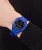 A person wearing a blue Adidas digital watch on their wrist. Náhled obrázku produktu