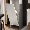A white laundry cabinet with a fold-out laundry bag is shown in a bathroom setting. Produktbild-Vorschau