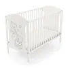 A white baby crib with a mattress and a drawing of two teddy bears on the side panel, set against a white background. Podgląd zdjęcia produktu