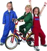 Three children in workwear outfits posing with a bicycle. Produktbild-Vorschau