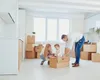 A family is unpacking boxes in a new home. Anteprima dell’immagine prodotto