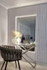A bedroom or dressing area with a large, illuminated mirror, a console table, and a decorative chair. Produktbild-Vorschau
