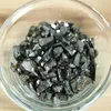 A clear glass bowl filled with small, dark, irregularly shaped stones. Anteprima dell’immagine prodotto