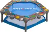 A colorful baby trampoline with a patterned safety cover. Anteprima dell’immagine prodotto