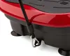 A close-up view of the side of a red and black vibration plate machine, showing a black resistance band attached to a metal carabiner clip. Náhled obrázku produktu