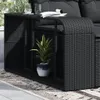 A close-up view of a black rattan storage shelf unit with a potted plant on it, placed on a rug outdoors. Náhled obrázku produktu