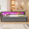 A modern grey daybed with pink LED lighting, decorated with pillows and a laptop. Podgląd zdjęcia produktu