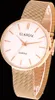A close-up studio shot of a rose gold women's watch with a white face and a mesh band. Produktbild-Vorschau