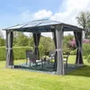 A gazebo set up in a garden with chairs and a table. Podgląd zdjęcia produktu