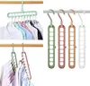 Multiple magic hangers in different colors holding clothes, displayed separately and in use. Produktbild-Vorschau