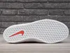 The sole of a Nike SB Force 58 shoe is shown against a brick wall and wooden floor. Produktbild-Vorschau