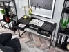 A modern black desk with drawers, a lamp, and books, set in a home office environment with a bookshelf and a chair. Voir les images du produit