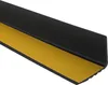 A close-up, angled view of a black stair nosing profile with yellow adhesive tape on the underside, set against a white background. Produktbild-Vorschau