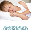 A young boy sleeping peacefully on a pillow. Produktbild-Vorschau