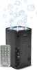 A black bubble machine with a remote control, producing bubbles and light effects. Náhľad obrázku produktu