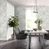 A dining room with a table, chairs, and a plant, featuring patterned wallpaper. Produktbild-Vorschau