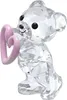 A clear studio shot of a crystal bear figurine holding a pink heart. Produktbild-Vorschau