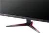 A close-up view of the base and lower part of a black computer monitor with red accents on its stand. Produktbild-Vorschau
