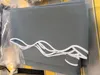 A folded gray awning fabric with a white wavy trim is shown. Produktbild-Vorschau