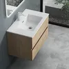 A modern bathroom vanity with a sink and faucet, set against a gray wall and concrete floor. Produktbild-Vorschau
