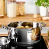 A stainless steel pot with pasta cooking in it, placed on a stovetop in a kitchen setting. Anteprima dell’immagine prodotto