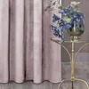 A close-up of a pink curtain with a small gold table holding a vase of blue flowers. Podgląd zdjęcia produktu