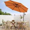 An outdoor dining set with chairs and a table under an orange cantilever umbrella. Produktbild-Vorschau
