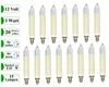 A collection of small, cream-colored candle-shaped light bulbs with clear tips, arranged in two rows on a white background. Text labels are present on the left side of the image, providing product specifications. Produktbild-Vorschau