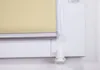 A close-up view of a roller blind mechanism attached to a window frame. Produktbild-Vorschau