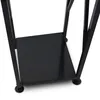 A close-up view of the bottom section of a black metal firewood rack, showing one of its shelves and legs. Produktbild-Vorschau
