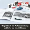 A book open to pages with car images, surrounded by small model car boxes and a blue model car. Náhľad obrázku produktu