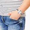A child's arm wearing a watch, with their hand in their jeans pocket. Produktbild-Vorschau