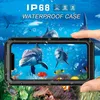 A hand holding a waterproof phone case with a marine life scene displayed on the screen, set against a background of sharks and dolphins. Náhled obrázku produktu