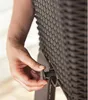 A hand is shown turning a valve on a brown textured planter, with water dripping out. Voir les images du produit
