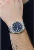 A person wearing a silver Guess watch with a blue dial on their wrist. Náhled obrázku produktu