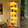A corner bookshelf with integrated LED lighting, filled with books and decorative items, next to a sofa and a large potted plant. Voir les images du produit