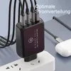 A close-up of a black multi-port USB charger plugged into a white power strip, with multiple cables connected. Produktbild-Vorschau