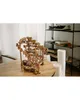 A wooden 3D mechanical puzzle of a marble run is displayed on a wooden table in a room with shelves in the background. Podgląd zdjęcia produktu