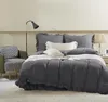 A bedroom scene with a bed, chair, and lamp. Podgląd zdjęcia produktu