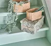 Storage boxes and baskets are placed on painted steps. Anteprima dell’immagine prodotto