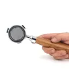 A hand holding a portafilter for an espresso machine. Podgląd zdjęcia produktu