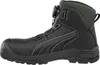 A side view of a black Puma safety boot with gray accents and a green collar, set against a white background. Produktbild-Vorschau